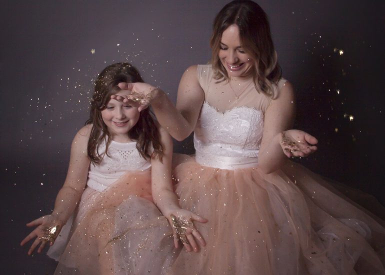 Girls playing with glitter in studio photoshoot