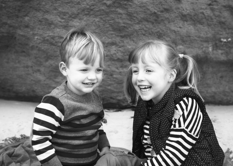 brother and sister laughing together