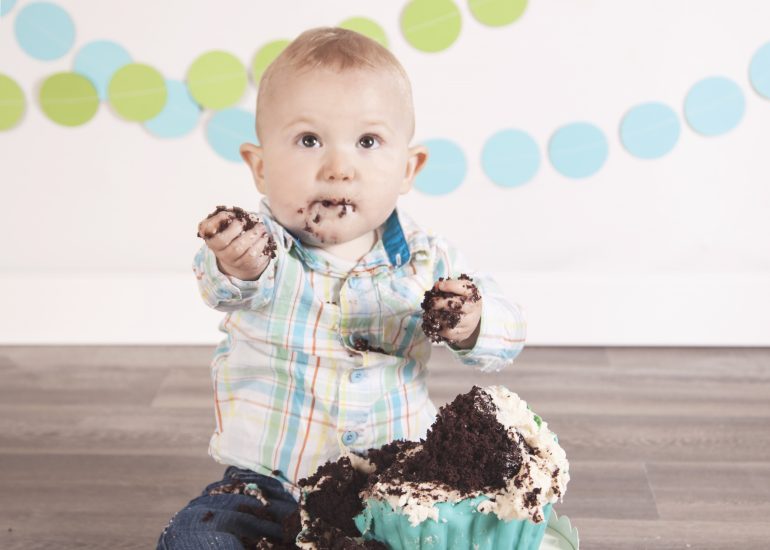 Boy smashing a chocolate cake