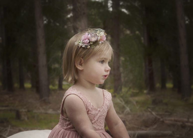 girl in pink dress with flowers in her hair