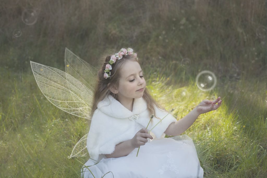 Princess with wings holding a bubble in her hand