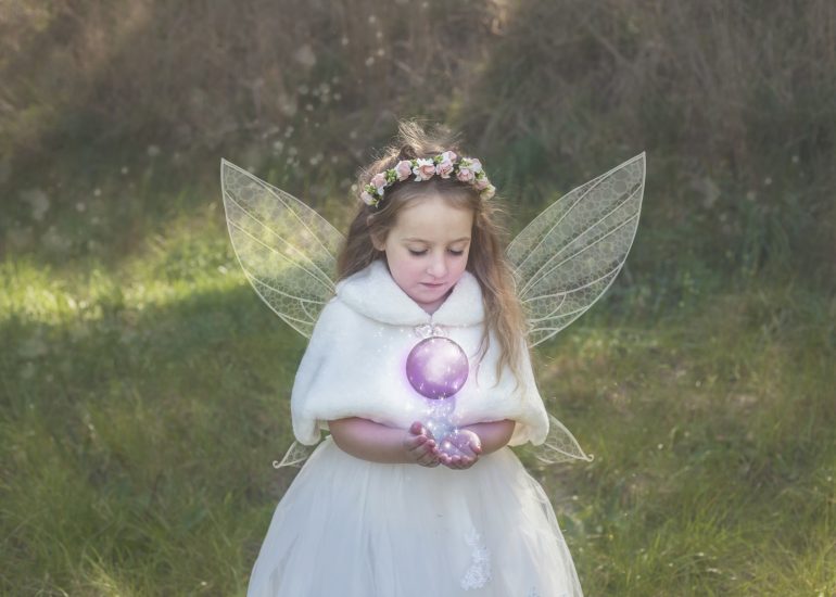 Girl with wings and a magical glowing ball